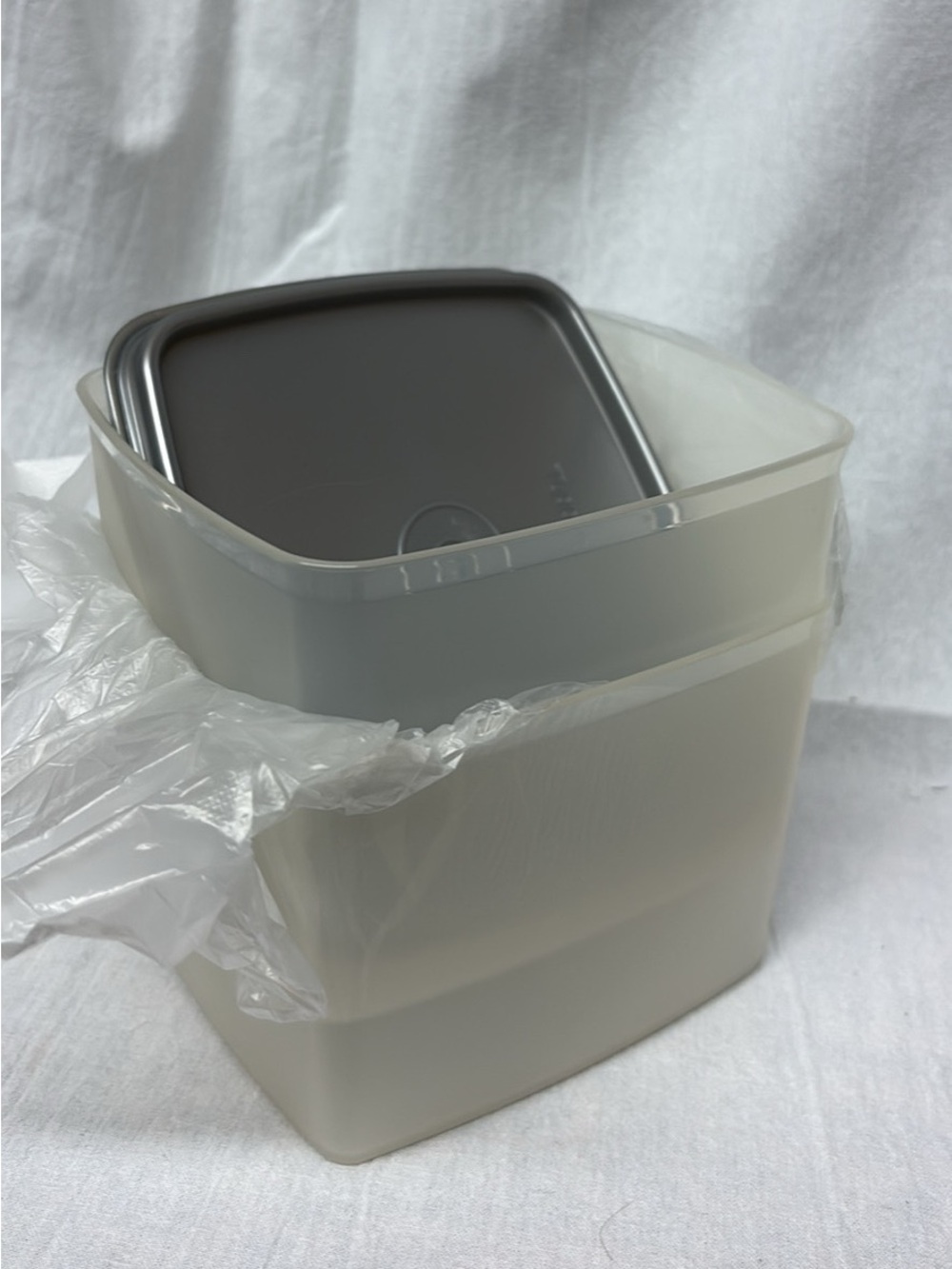 Two Tupperware Containers with silver lids